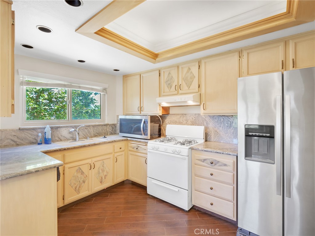 2910 Malaga Circle, Unit A Diamond Bar, CA 91765 - Photo 13 of 52 a kitchen with a sink a window and cabinets