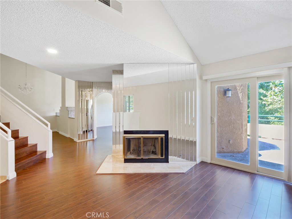 2910 Malaga Circle, Unit A Diamond Bar, CA 91765 - Photo 6 of 52 a view of an empty room with wooden floor fireplace and a window