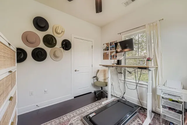 walk in closet with wooden floor