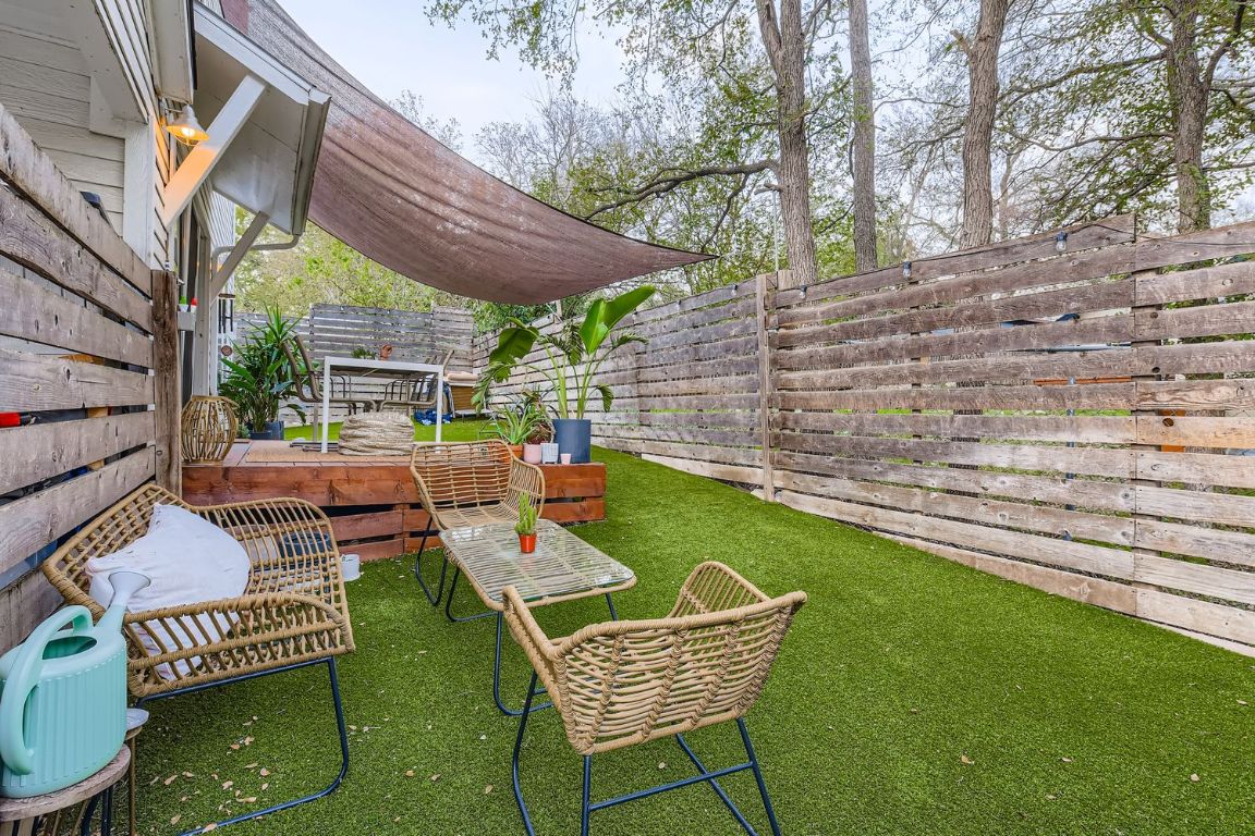1213 Eleanor Street, Unit B Austin, TX 78721 - Photo 17 of 17 a view of a patio with a table chairs and a backyard