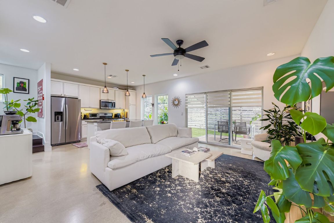 1213 Eleanor Street, Unit B Austin, TX 78721 - Photo 3 of 17 a living room with furniture floor to ceiling window and a potted plant