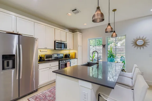 a kitchen with refrigerator cabinets and furniture