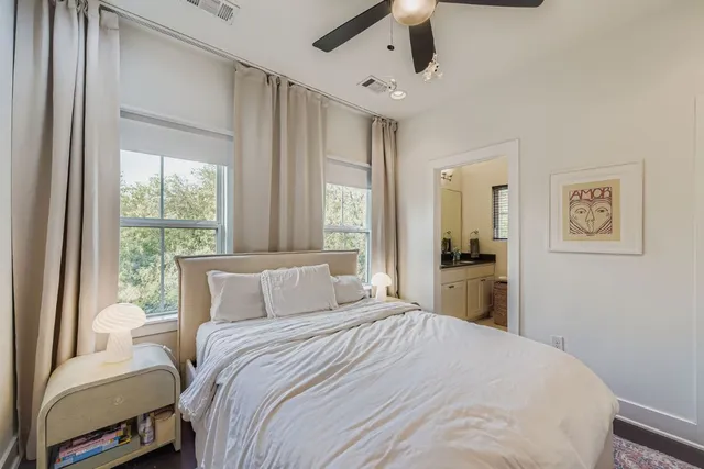 a bedroom with a large bed and a window