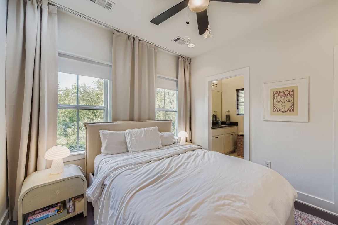 1213 Eleanor Street, Unit B Austin, TX 78721 - Photo 9 of 17 a bedroom with a large bed and a window