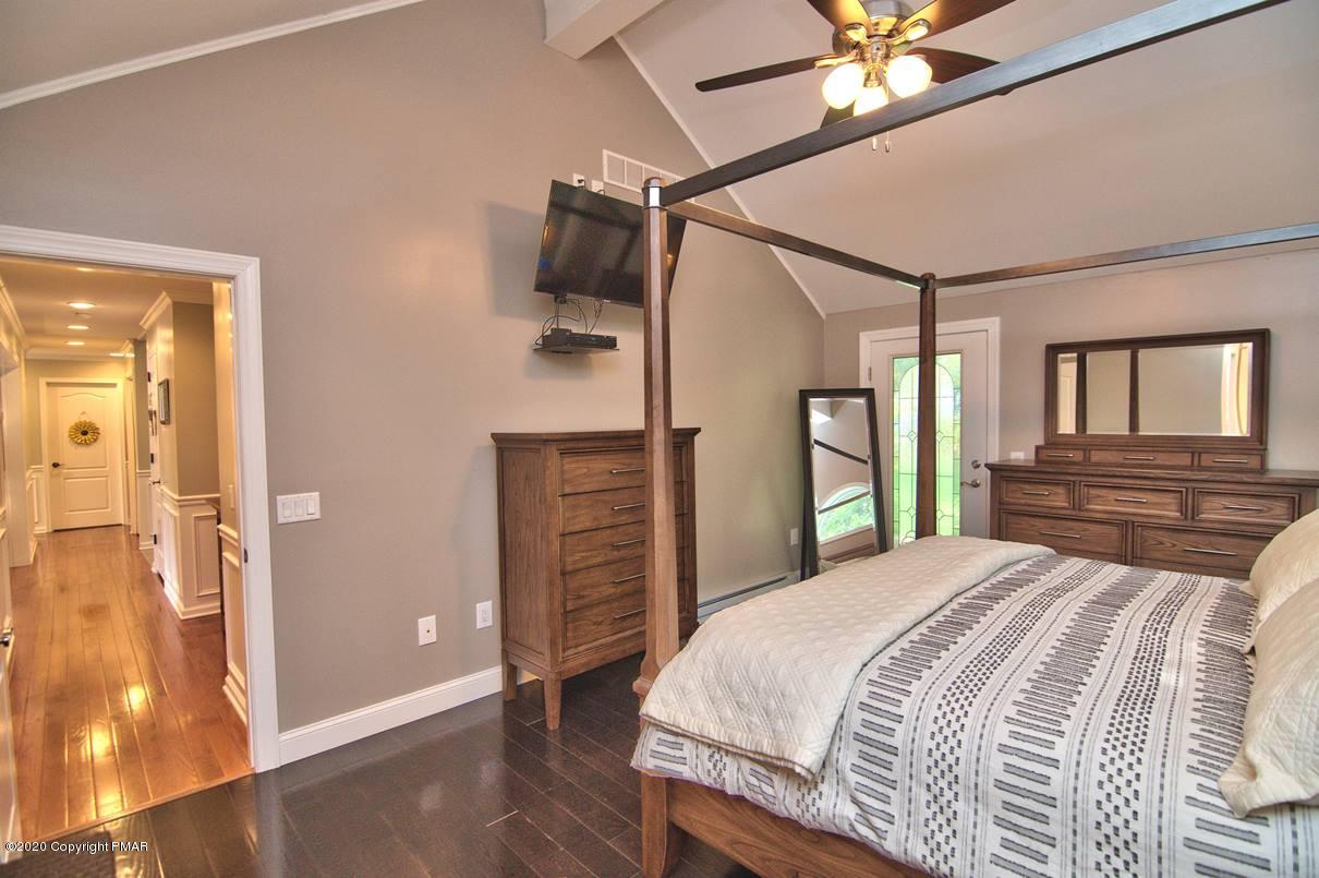 659 Behrens Road Jim Thorpe, PA 18229 - Photo 42 of 116 a bedroom with a large bed and a chandelier