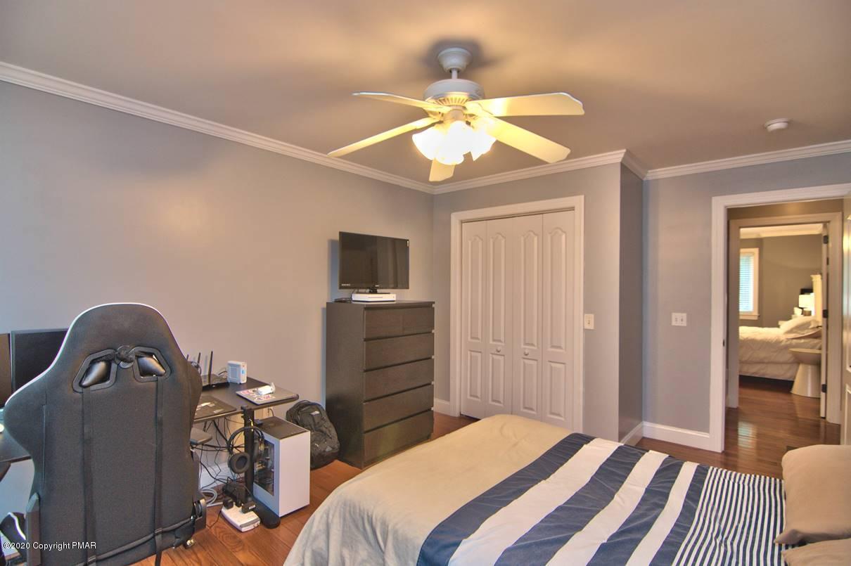 659 Behrens Road Jim Thorpe, PA 18229 - Photo 65 of 116 a bedroom with a bed and a chandelier