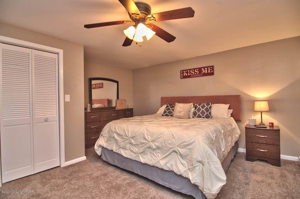 659 Behrens Road Jim Thorpe, PA 18229 - Photo 66 of 116 a bedroom with a bed and a chandelier