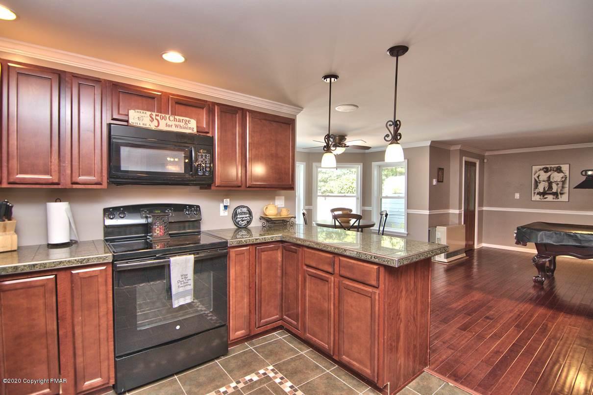 659 Behrens Road Jim Thorpe, PA 18229 - Photo 79 of 116 a kitchen with stainless steel appliances granite countertop a stove a sink dishwasher and microwave with wooden floor