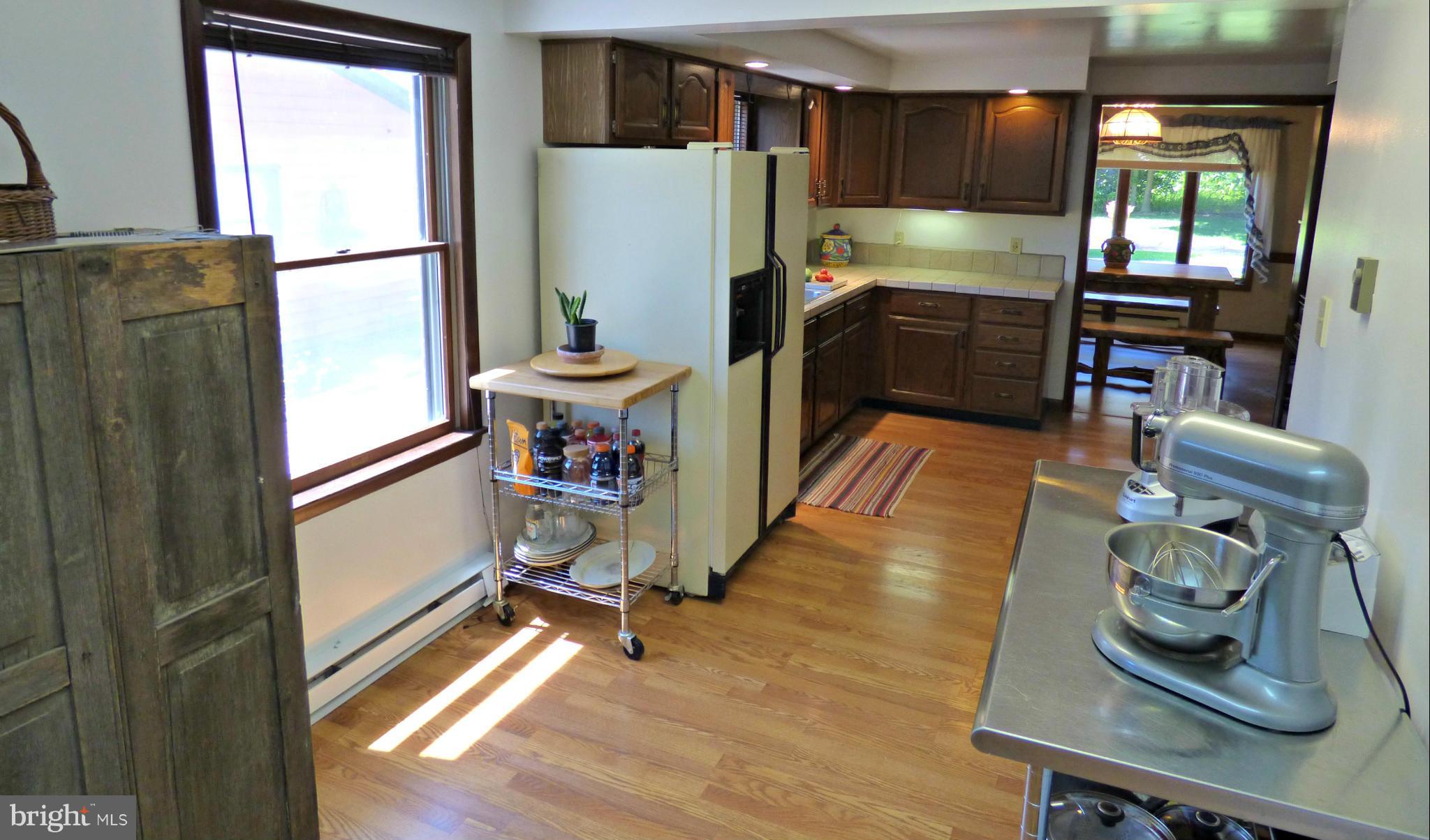8409 Mapleville Road Mount Airy, MD 21771 - Photo 13 of 30 a kitchen with stainless steel appliances granite countertop a refrigerator and a stove