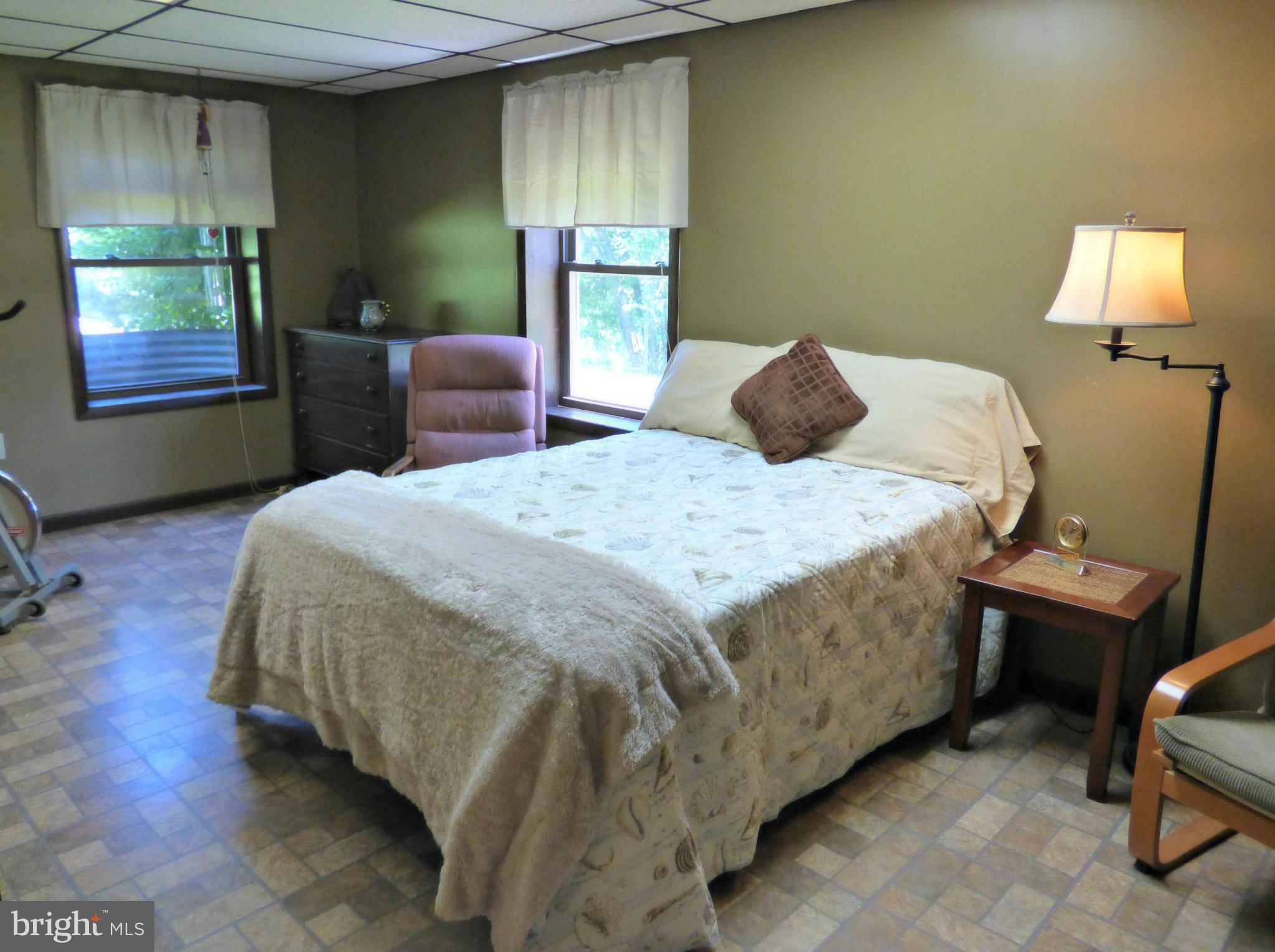 8409 Mapleville Road Mount Airy, MD 21771 - Photo 16 of 30 a bedroom with a bed and a chair