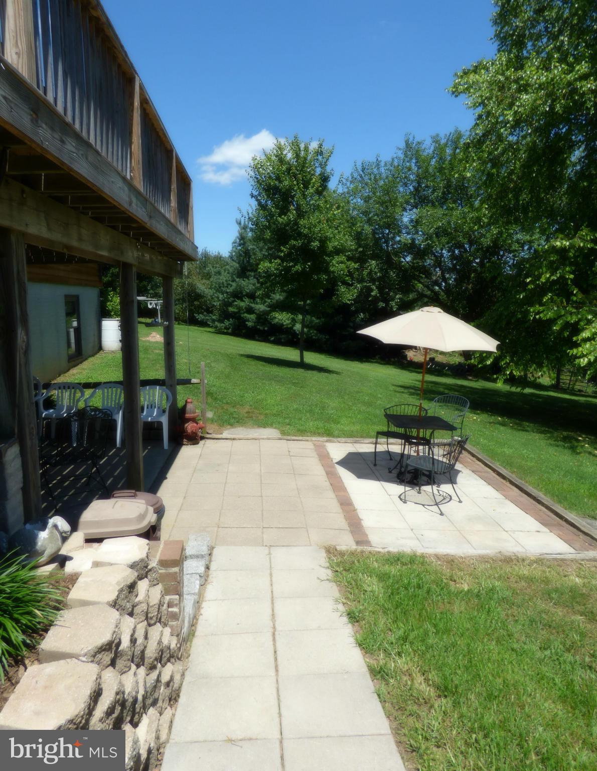 8409 Mapleville Road Mount Airy, MD 21771 - Photo 22 of 30 a view of backyard with outdoor seating a patio and a garden