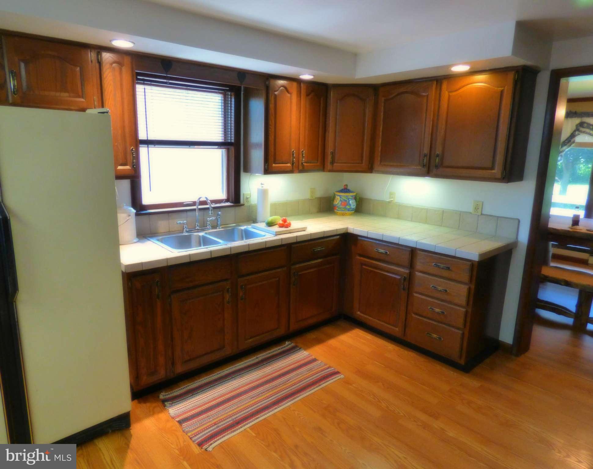 8409 Mapleville Road Mount Airy, MD 21771 - Photo 7 of 30 a kitchen with a sink and cabinets