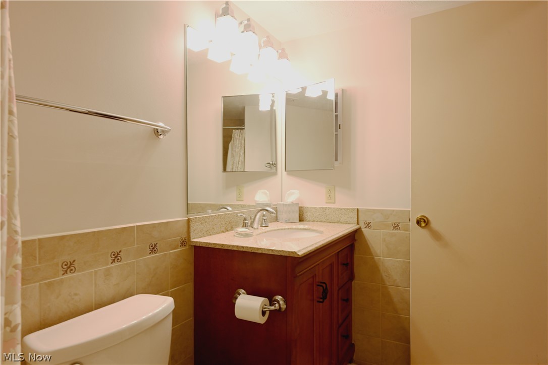 22962 Maple Ridge Road, Unit 108 North Olmsted, OH 44070 - Photo 22 of 37 Bathroom with tile walls, large vanity, and toilet