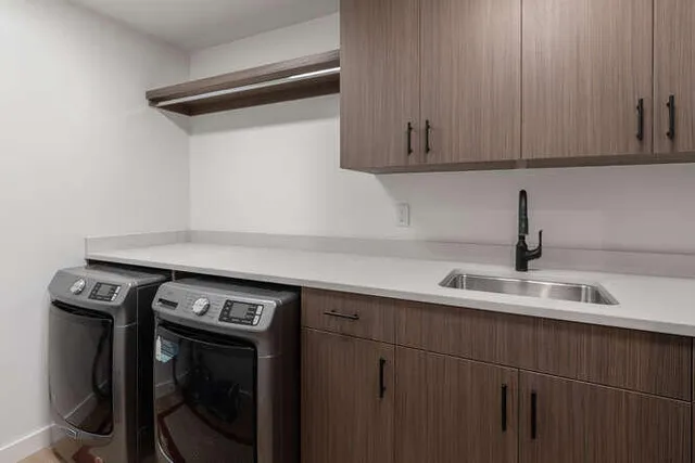 a view of a sink with washer and dryer