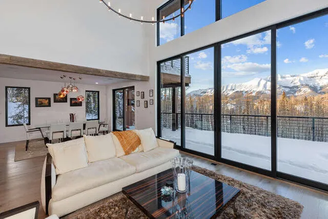 a living room with furniture and a floor to ceiling window