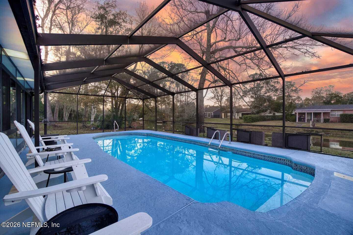 11613 Lake Ride Drive Jacksonville, FL 32223 - Photo 4 of 42 a view of a swimming pool with seating space