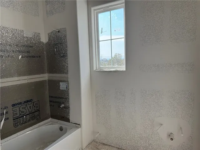 a bathroom with a tub and shower