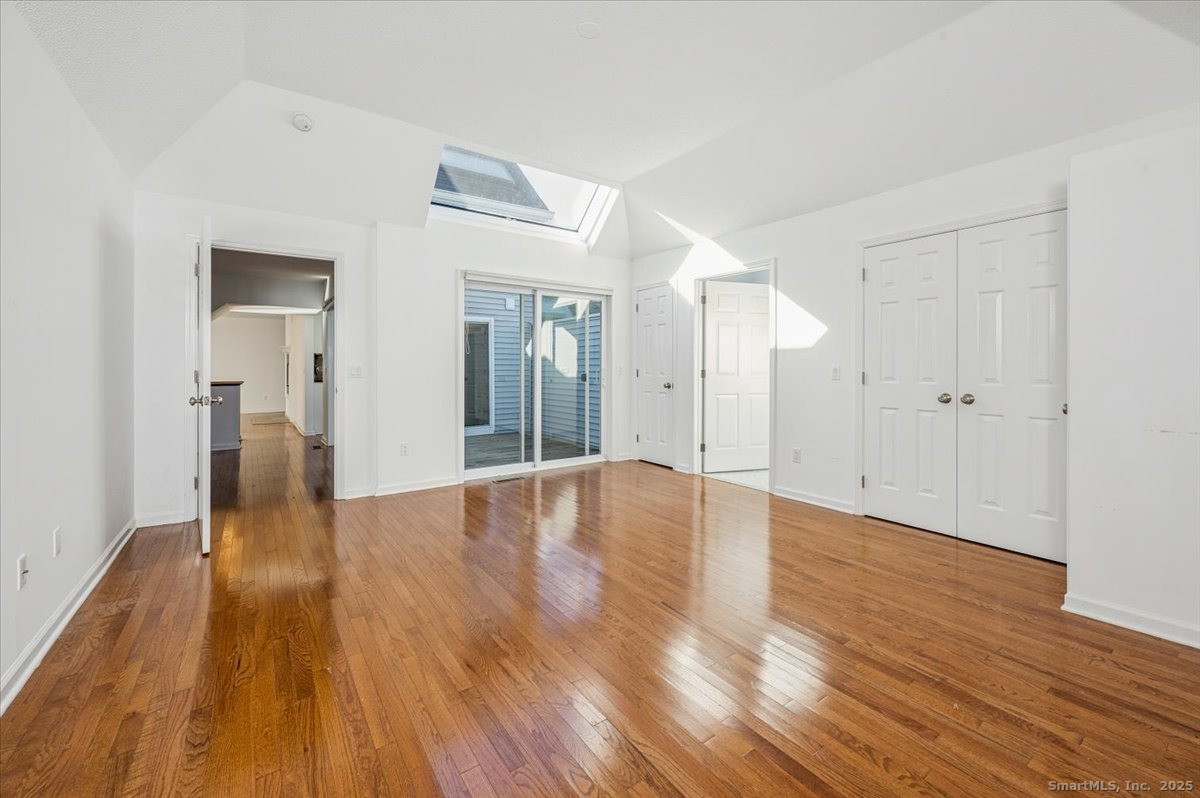 66 Wilton Crest Road, Unit 66 Wilton, CT 06897 - Photo 12 of 25 a view of a big room with wooden floor and windows