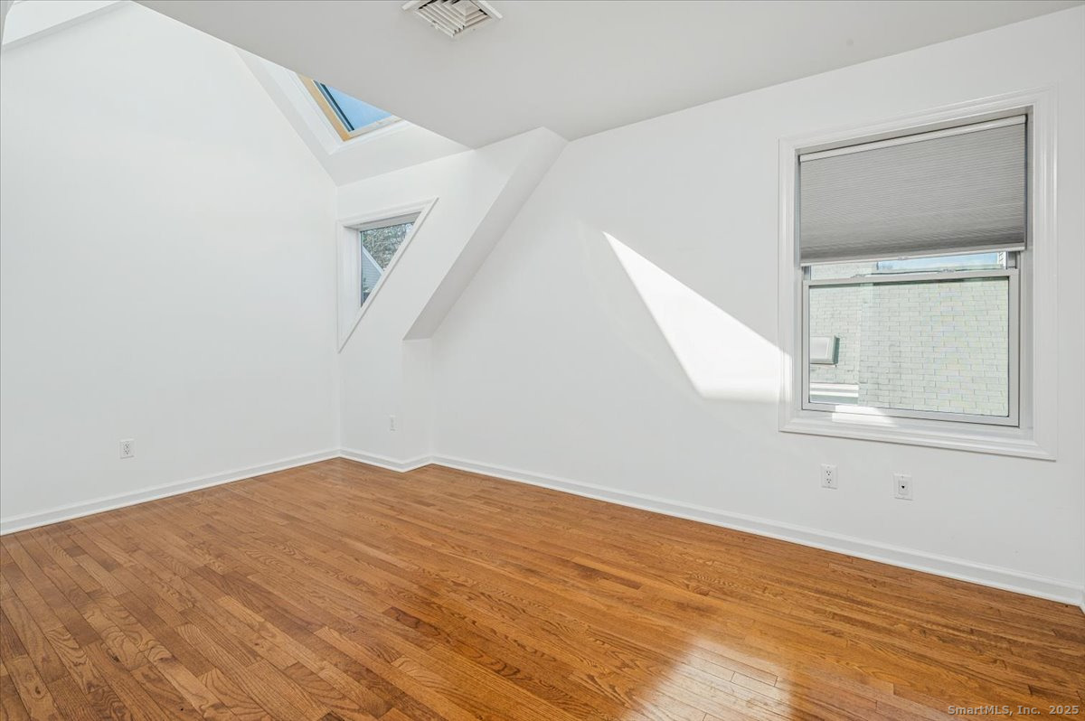 66 Wilton Crest Road, Unit 66 Wilton, CT 06897 - Photo 16 of 25 a view of empty room with wooden floor and fan