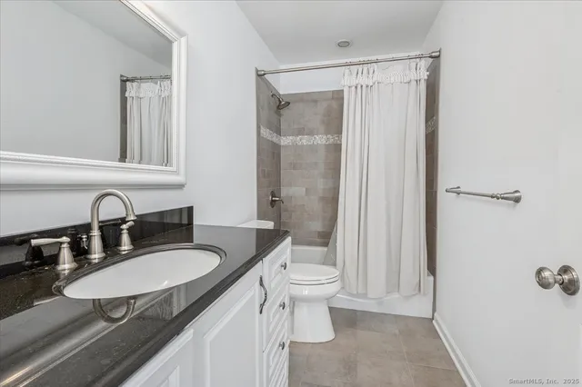 a bathroom with a sink toilet a mirror and shower