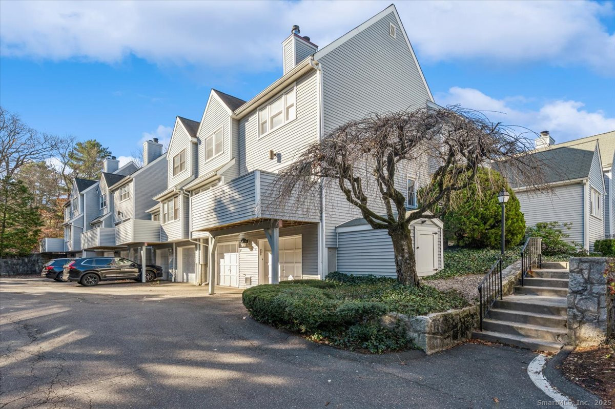 66 Wilton Crest Road, Unit 66 Wilton, CT 06897 - Photo 22 of 25 a front view of a house with a garden