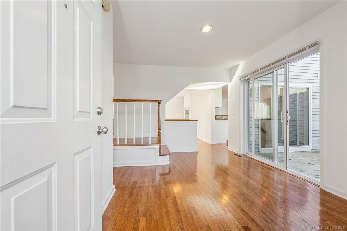 66 Wilton Crest Road, Unit 66 Wilton, CT 06897 - Photo 3 of 25 a view of a big room with wooden floor and windows