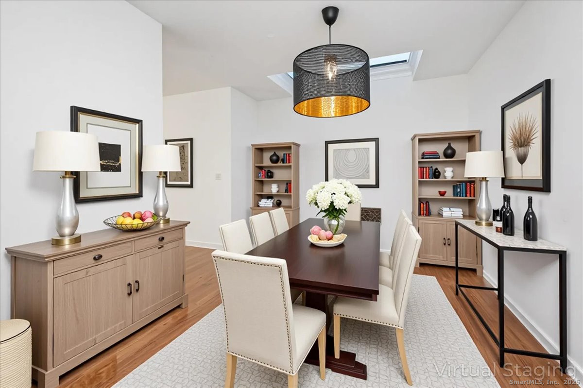 66 Wilton Crest Road, Unit 66 Wilton, CT 06897 - Photo 5 of 25 a view of a dining room with furniture and wooden floor