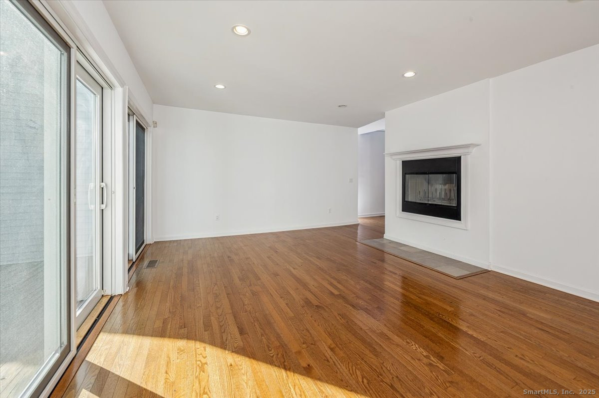 66 Wilton Crest Road, Unit 66 Wilton, CT 06897 - Photo 8 of 25 a view of an empty room and wooden floor