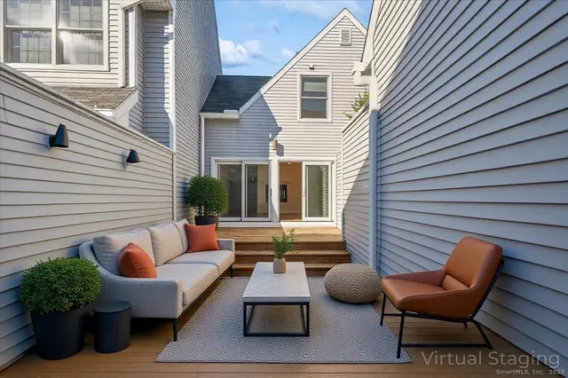 a view of a patio with couches chairs and potted plants