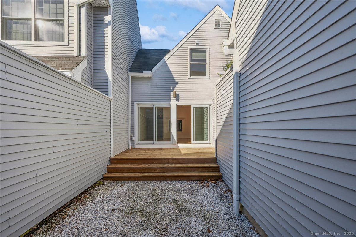 66 Wilton Crest Road, Unit 66 Wilton, CT 06897 - Photo 10 of 25 a view of a house with a yard and a large window