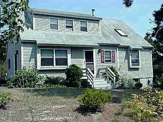 Undisclosed Address Mashpee, MA 02649 - Photo 1 of 4 a front view of a house with garden