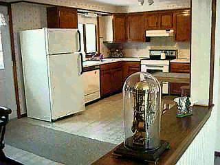 Undisclosed Address Mashpee, MA 02649 - Photo 3 of 4 a kitchen with a refrigerator a stove and cabinets