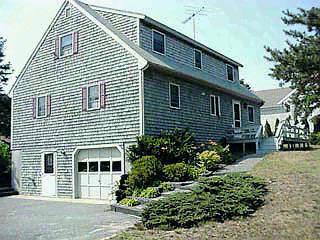 Undisclosed Address Mashpee, MA 02649 - Photo 4 of 4 a front view of a house with a yard