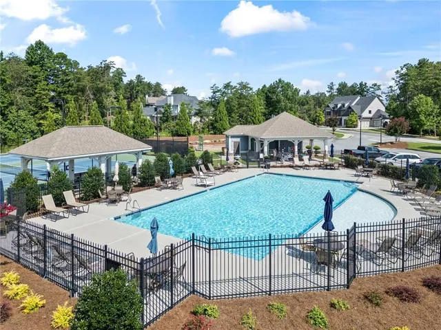 an outdoor space with seating area and trees