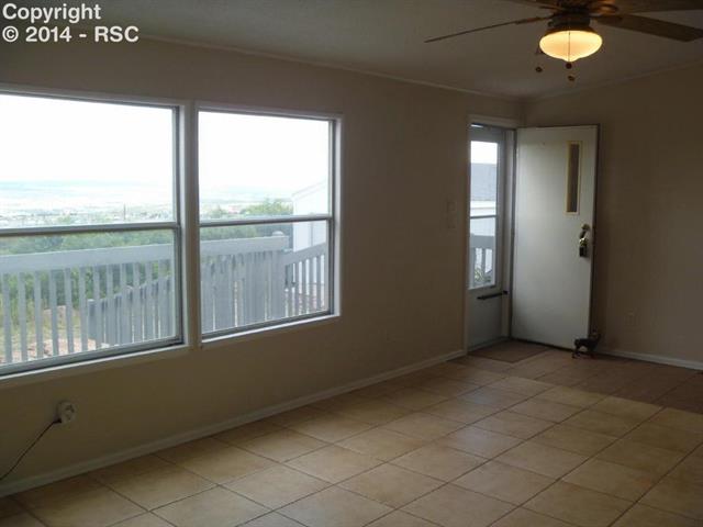 4535 Evans Road Monument, CO 80132 - Photo 3 of 23 Front entry into the tiled living room