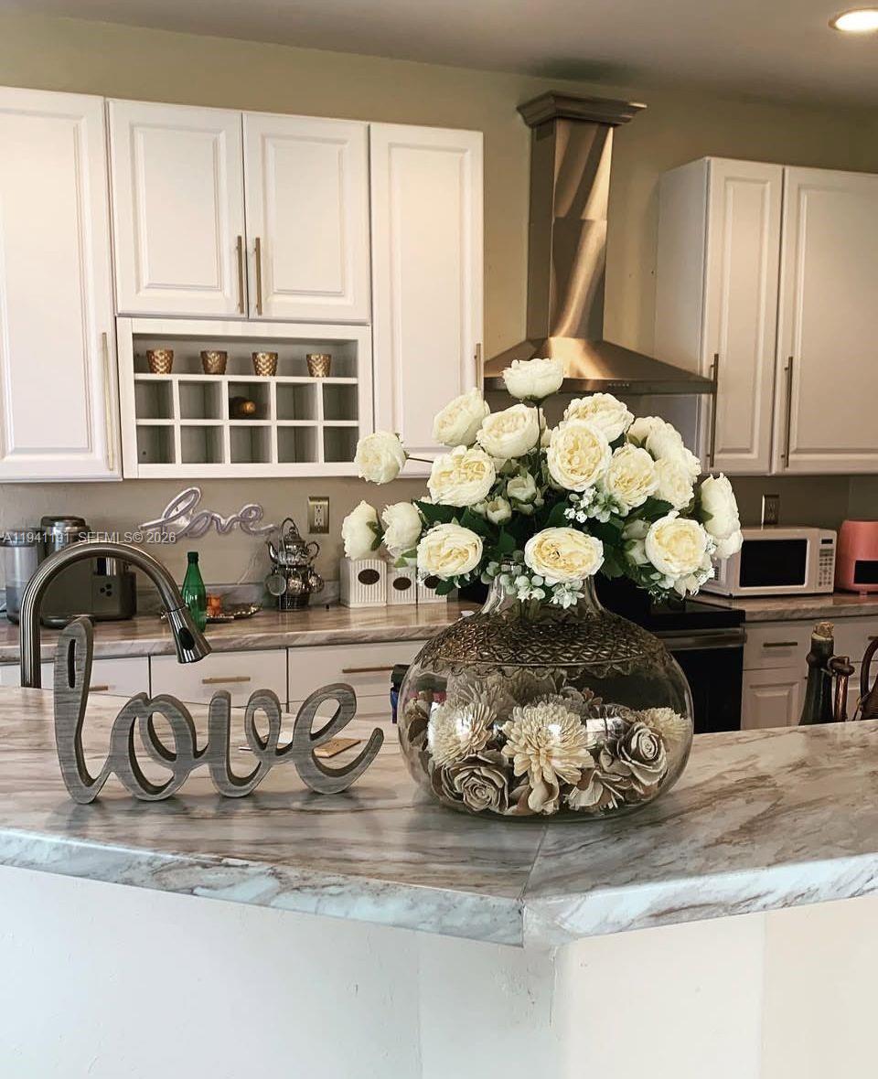 1531 Southeast 20th Road Homestead, FL 33035 - Photo 3 of 10 a close view of a granite counter top a sink and a stove