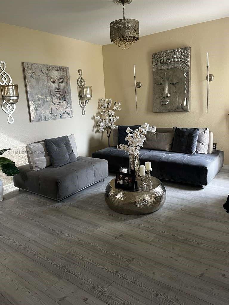 1531 Southeast 20th Road Homestead, FL 33035 - Photo 4 of 10 a living room with furniture and a chandelier