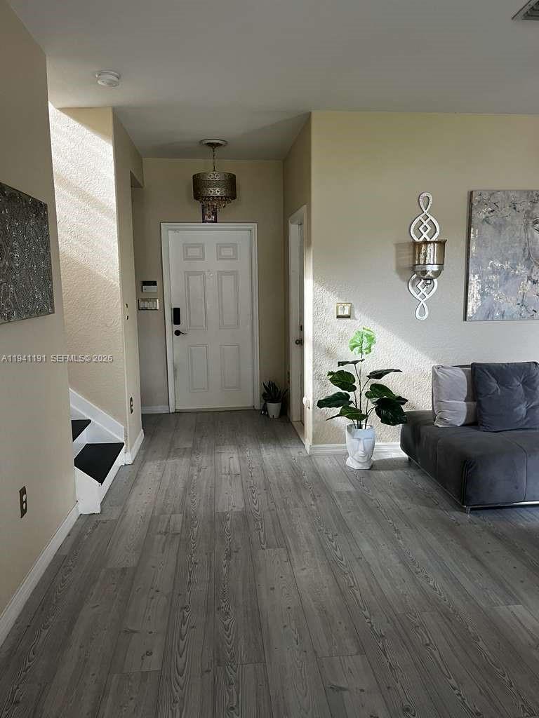 1531 Southeast 20th Road Homestead, FL 33035 - Photo 8 of 10 a living room with furniture and a wooden floor