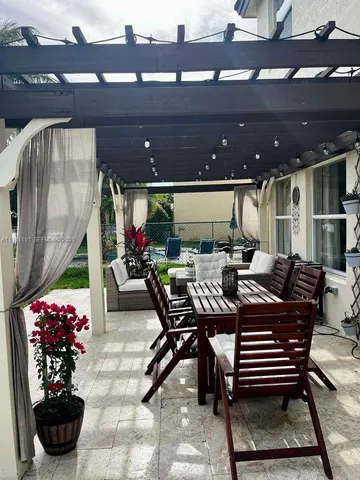 a outdoor dining space with furniture and a potted plant