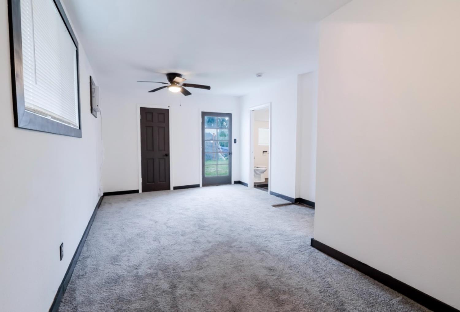 2331 Downar Way Sacramento, CA 95838 - Photo 16 of 23 an empty room with ceiling fan and window
