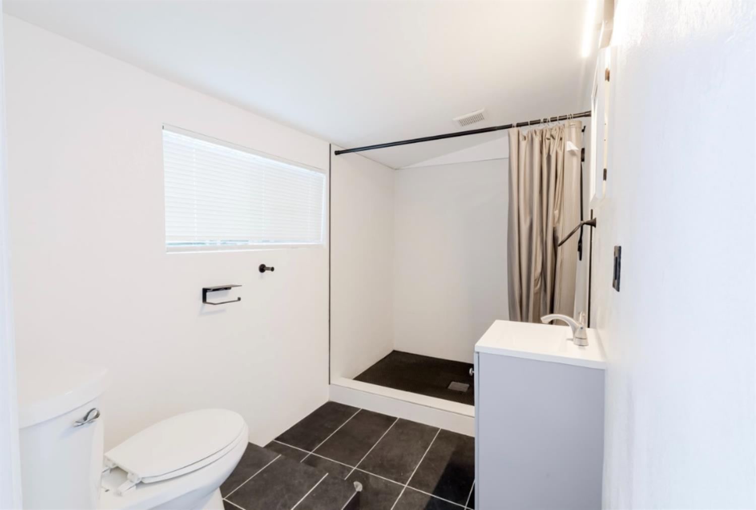 2331 Downar Way Sacramento, CA 95838 - Photo 19 of 23 a bathroom with a sink a toilet a mirror and shower