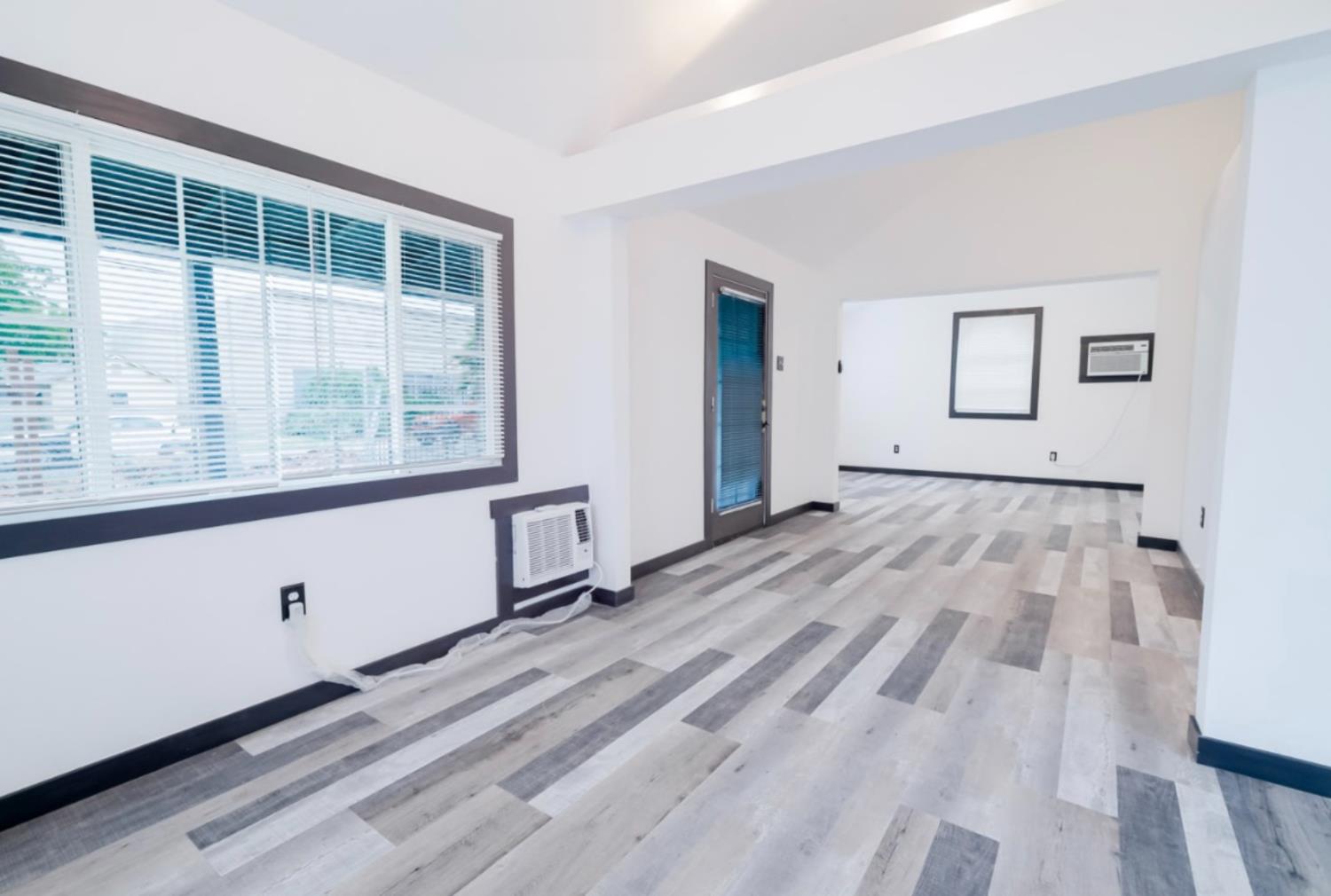 2331 Downar Way Sacramento, CA 95838 - Photo 7 of 23 a view of empty room with wooden floor and windows