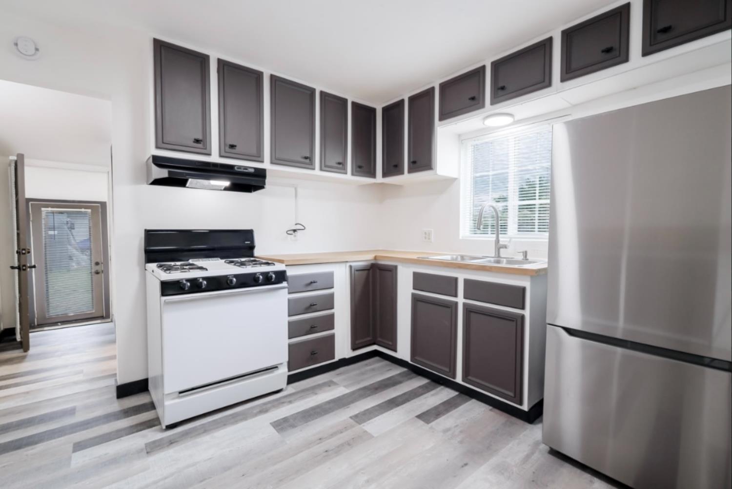 2331 Downar Way Sacramento, CA 95838 - Photo 8 of 23 a kitchen with stainless steel appliances a stove a microwave and a refrigerator