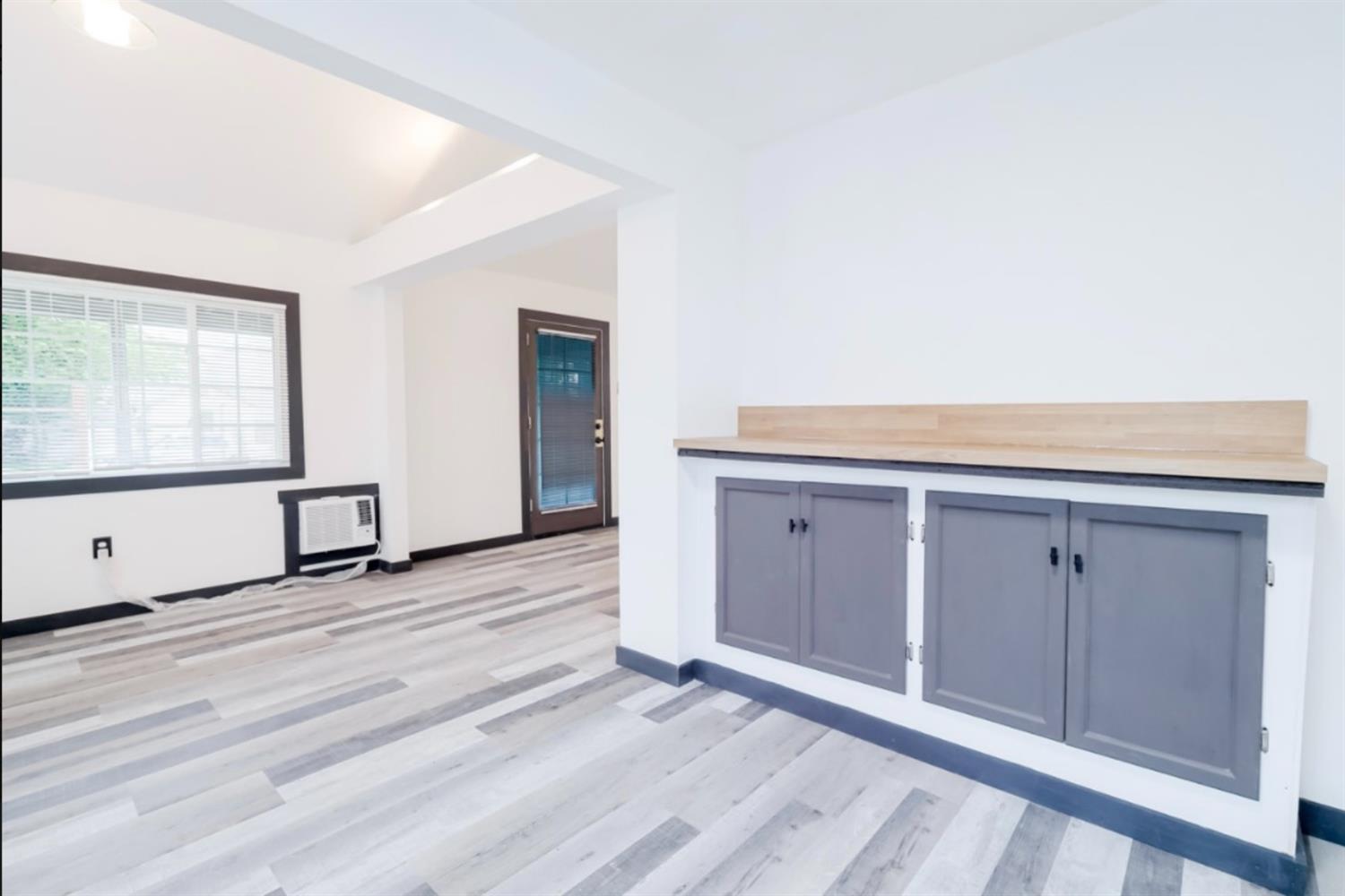 2331 Downar Way Sacramento, CA 95838 - Photo 10 of 23 an empty room with wooden floor and windows