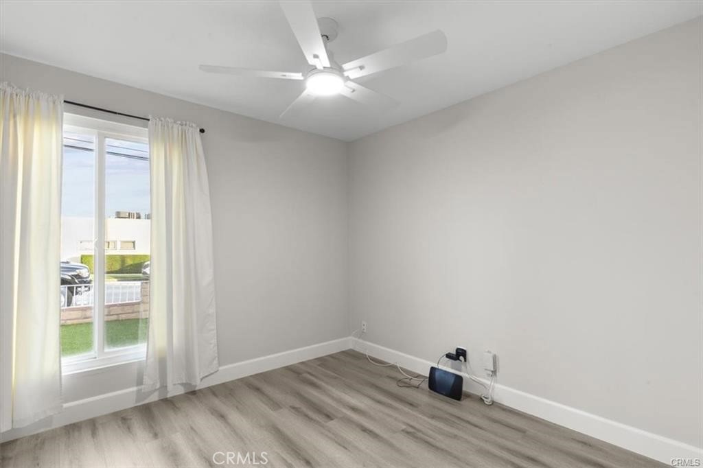 1353 Termino Avenue Long Beach, CA 90804 - Photo 17 of 30 an empty room with wooden floor and windows