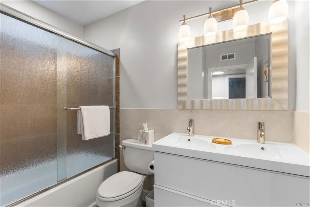 1353 Termino Avenue Long Beach, CA 90804 - Photo 18 of 30 a bathroom with a sink a mirror and a toilet