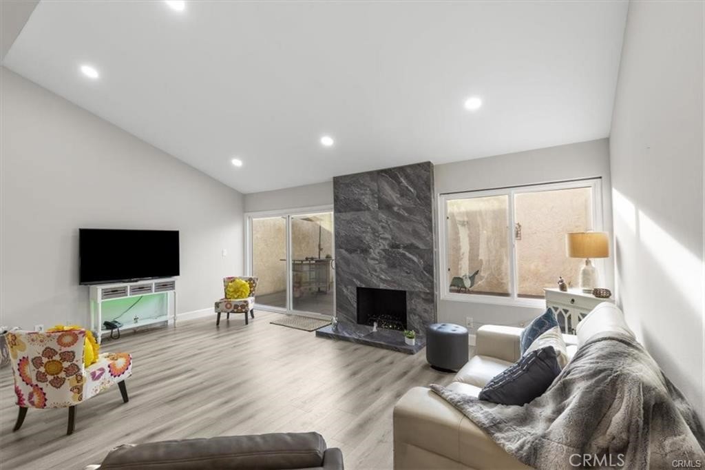 1353 Termino Avenue Long Beach, CA 90804 - Photo 3 of 30 a living room with furniture a flat screen tv and a fireplace