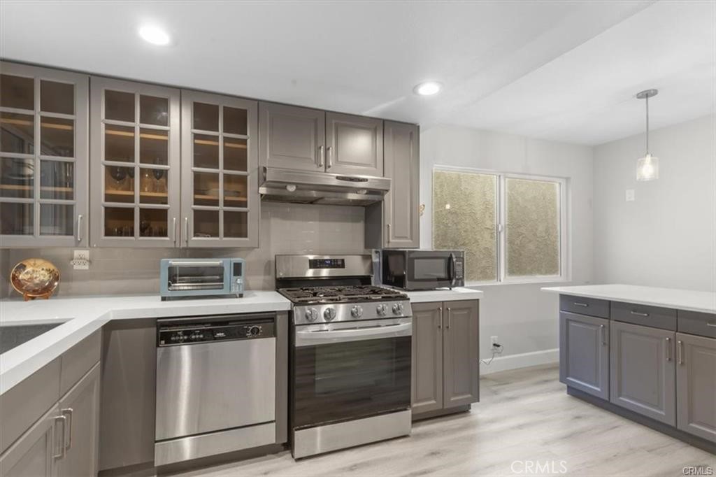 1353 Termino Avenue Long Beach, CA 90804 - Photo 10 of 30 a kitchen with granite countertop a stove sink and cabinets