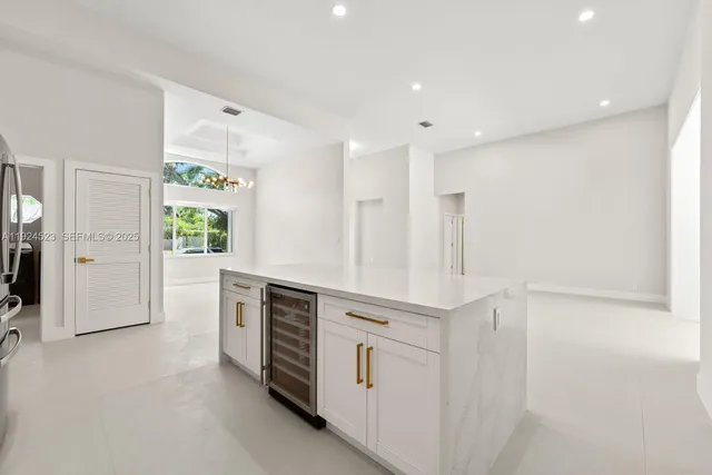 a large white kitchen with cabinets and stainless steel appliances