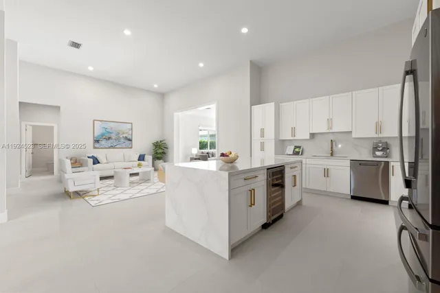a kitchen with stainless steel appliances a sink stove and cabinets